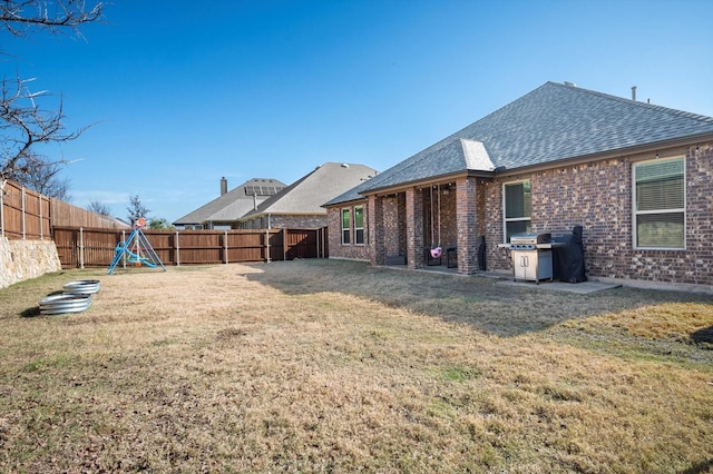 back of house with a lawn