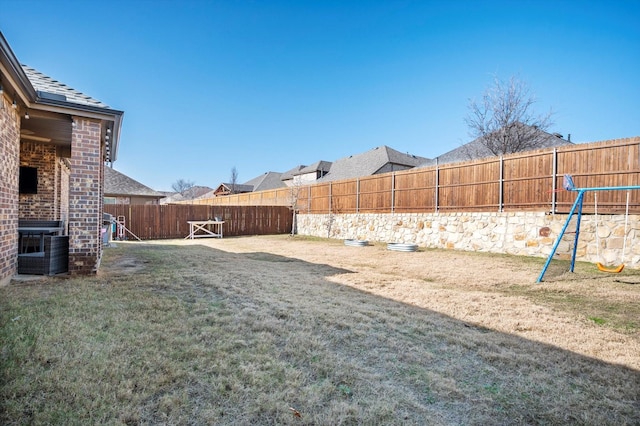 view of yard with a playground and central air condition unit