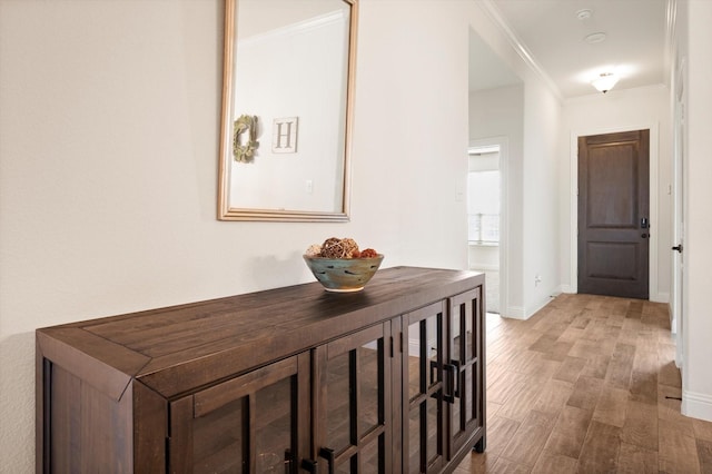 corridor featuring hardwood / wood-style floors and ornamental molding