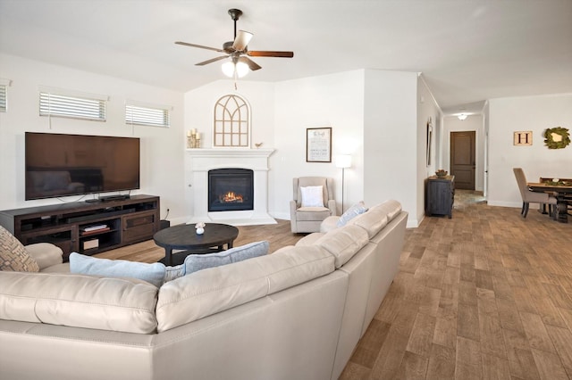 living room featuring hardwood / wood-style flooring, ceiling fan, a healthy amount of sunlight, and lofted ceiling