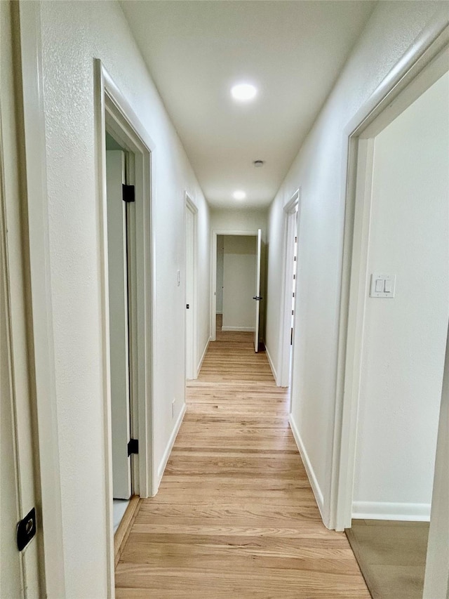 hall with light hardwood / wood-style floors