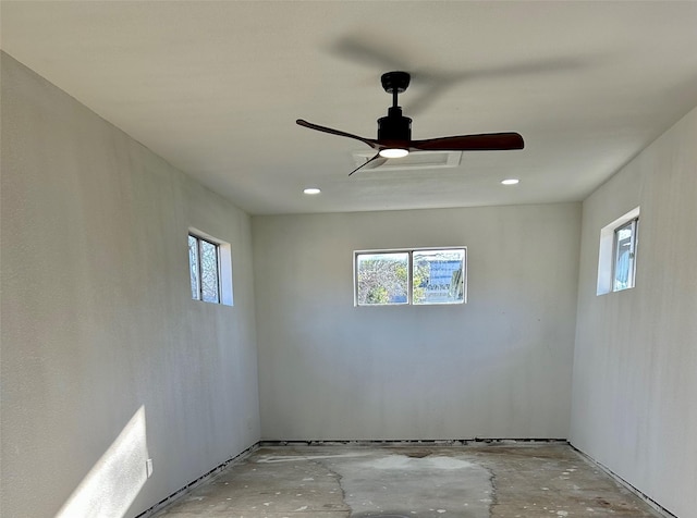 empty room featuring ceiling fan and plenty of natural light