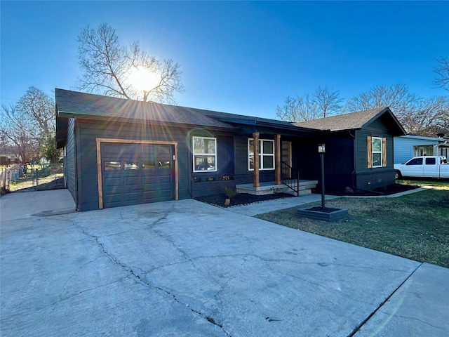 single story home with a garage and a front lawn