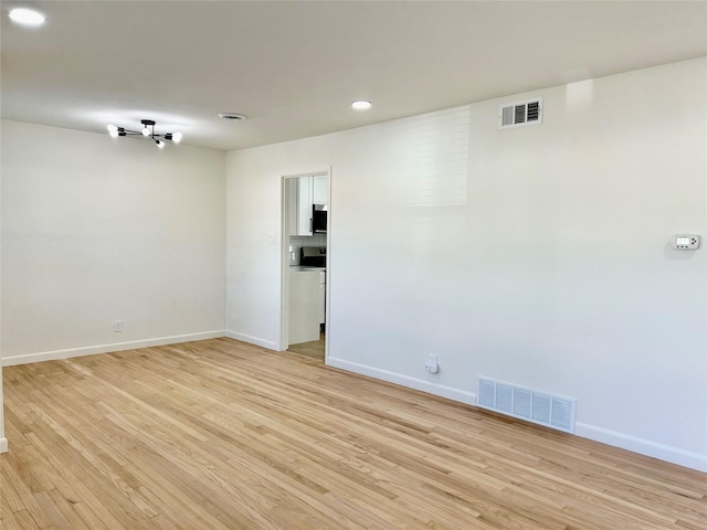 spare room featuring light wood-type flooring