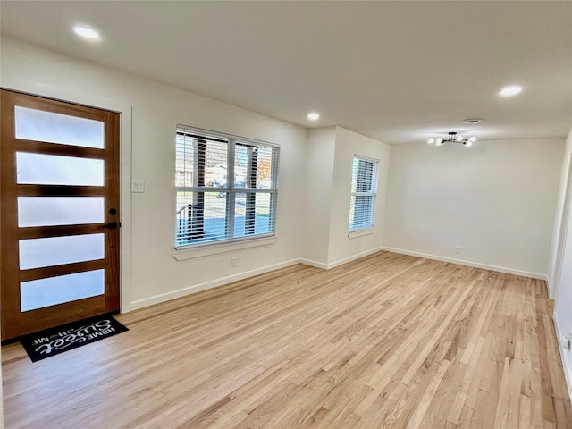 foyer entrance with light hardwood / wood-style floors