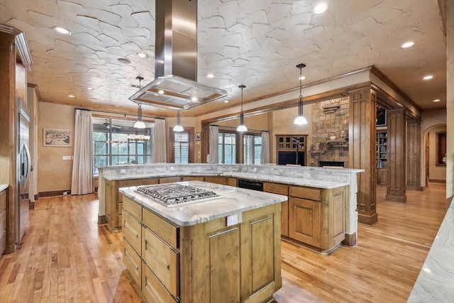 kitchen featuring ornamental molding, island range hood, pendant lighting, stainless steel gas stovetop, and a large island