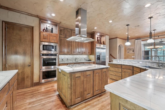 kitchen featuring a center island, sink, light hardwood / wood-style flooring, built in appliances, and island range hood