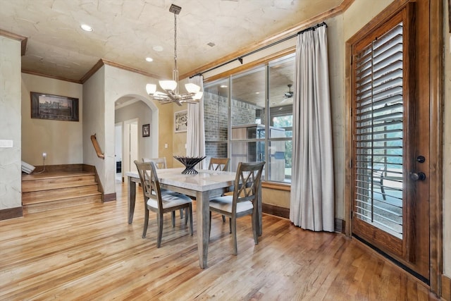 dining room featuring a chandelier, light hardwood / wood-style flooring, and ornamental molding