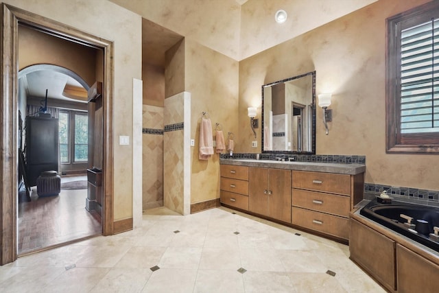 bathroom with vanity and shower with separate bathtub