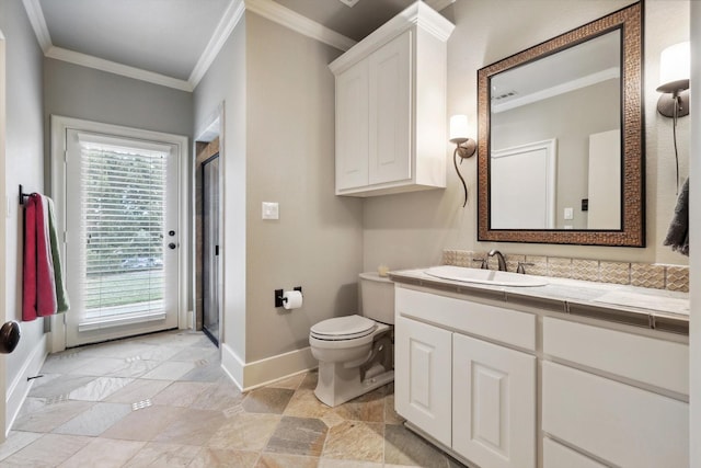 bathroom featuring vanity, toilet, and crown molding