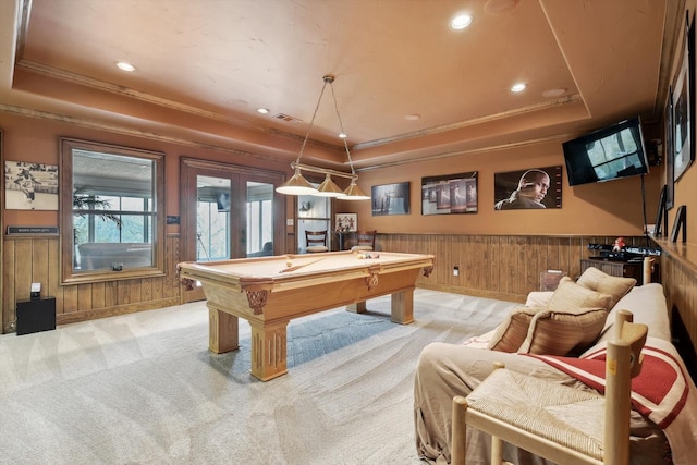 playroom featuring a tray ceiling, wood walls, light colored carpet, and pool table