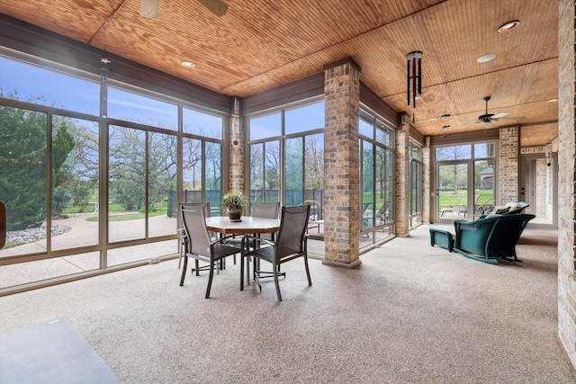 sunroom featuring ceiling fan and wood ceiling