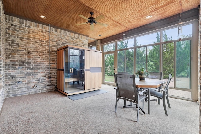 sunroom / solarium with ceiling fan and wood ceiling