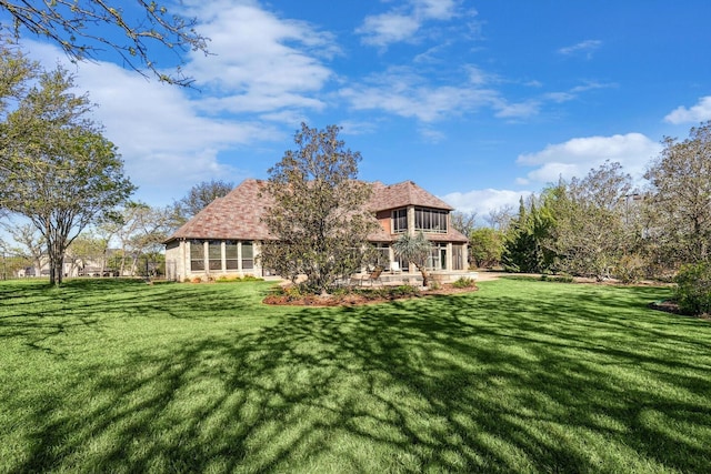 back of house with a yard and a patio