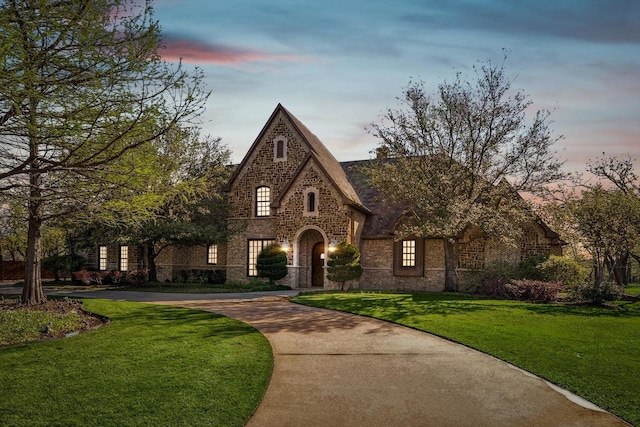 tudor house featuring a lawn