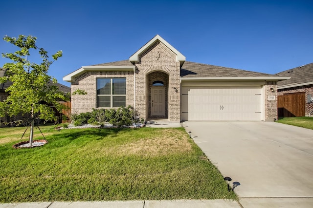 view of front of house with a garage and a front lawn