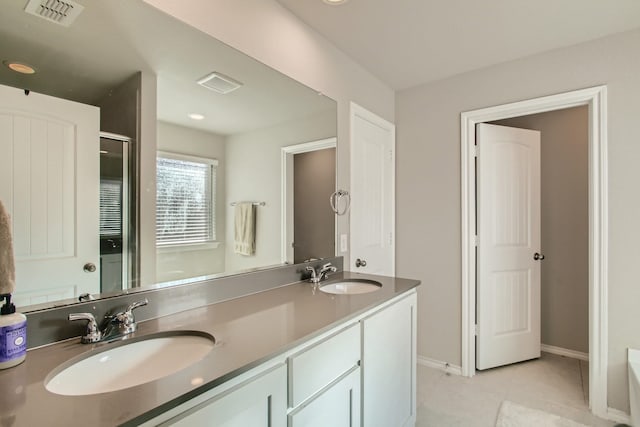 bathroom with tile patterned flooring and vanity