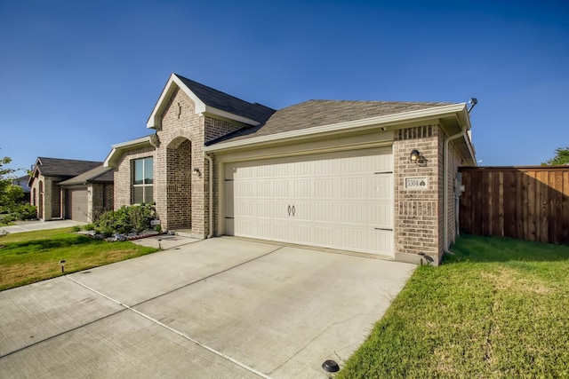 single story home with a garage and a front lawn