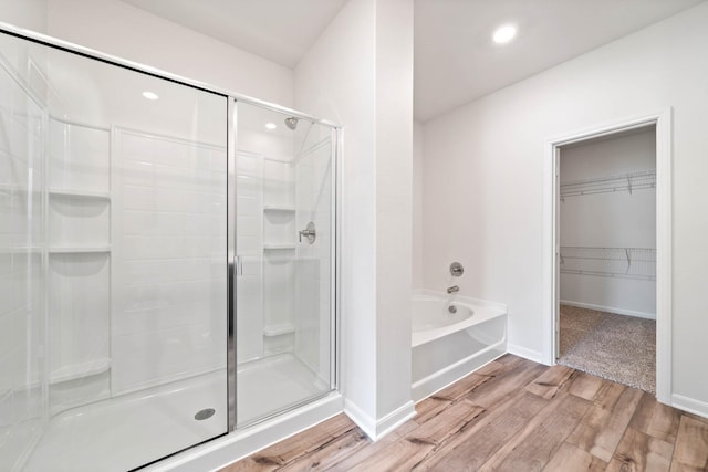 bathroom featuring hardwood / wood-style flooring and independent shower and bath