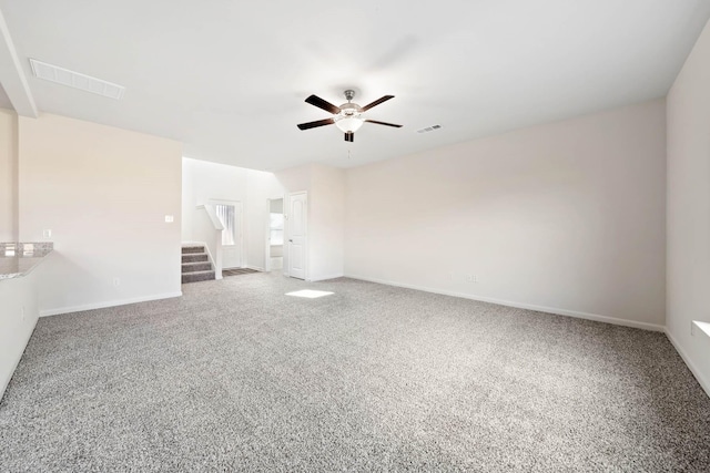 spare room featuring ceiling fan and carpet floors