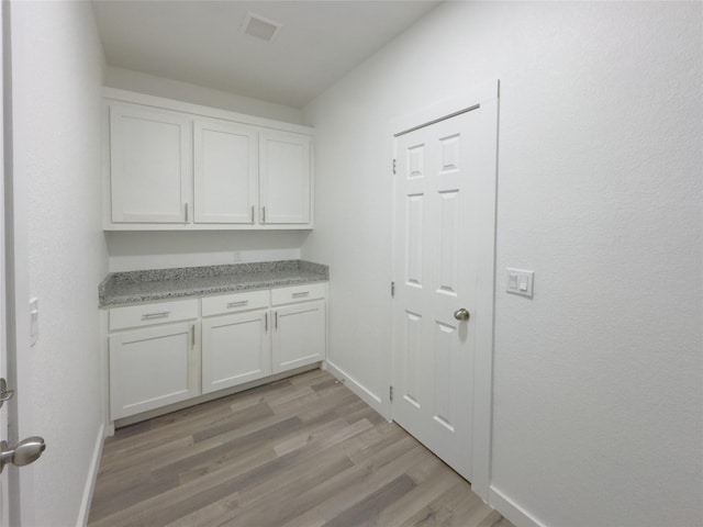 laundry room with light hardwood / wood-style floors