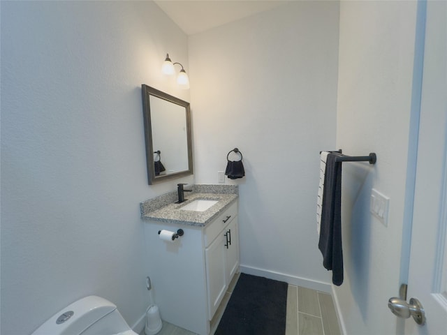 bathroom featuring vanity and toilet