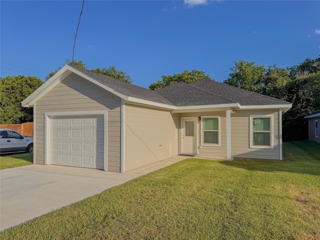 ranch-style house featuring a garage and a front lawn