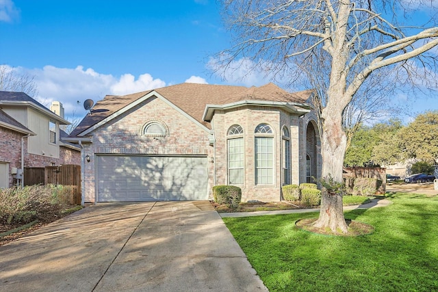 view of front facade with a garage and a front lawn