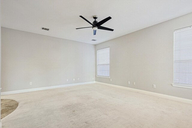 carpeted empty room featuring ceiling fan