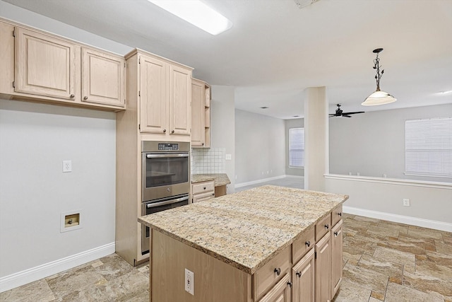 kitchen featuring light brown cabinetry, tasteful backsplash, and double oven