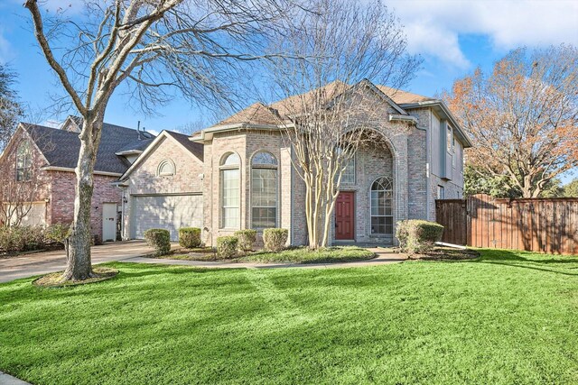 view of front of home with a garage and a front lawn