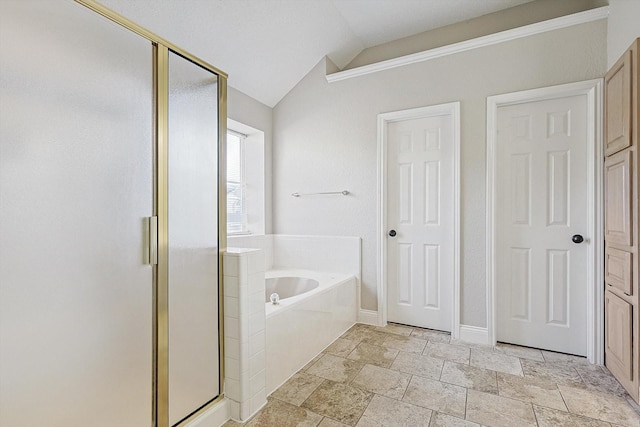 bathroom featuring independent shower and bath and vaulted ceiling