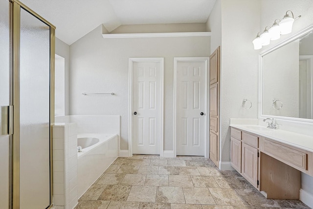 bathroom featuring vanity, separate shower and tub, and lofted ceiling