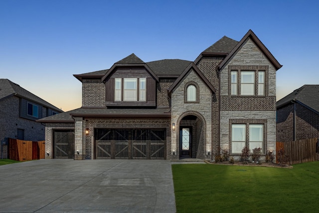 view of front facade with a garage and a lawn