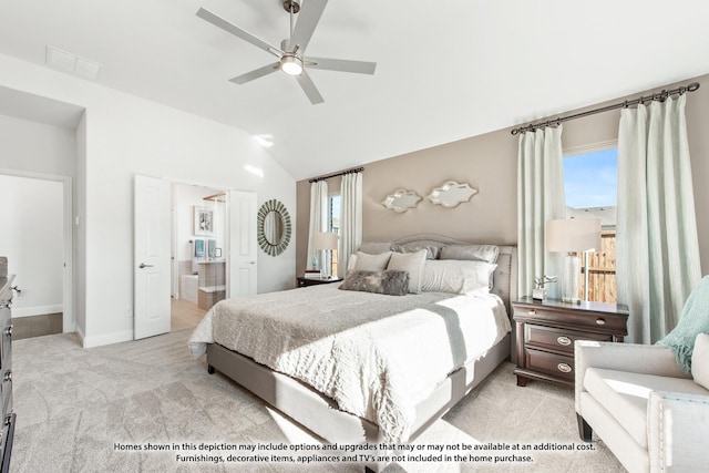 carpeted bedroom with ceiling fan, lofted ceiling, and ensuite bathroom