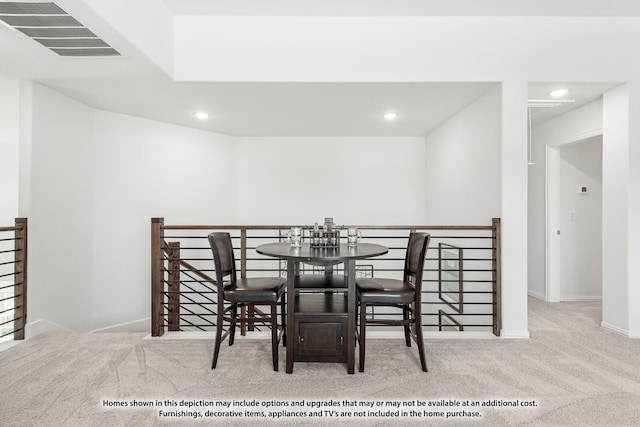 dining room featuring light carpet