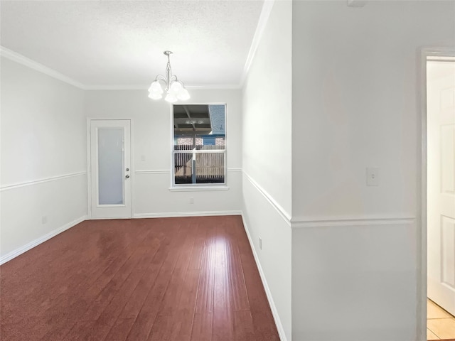 unfurnished room with a chandelier, wood-type flooring, a textured ceiling, and crown molding