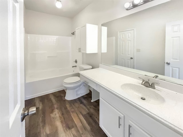 full bathroom with shower / washtub combination, hardwood / wood-style floors, vanity, and toilet