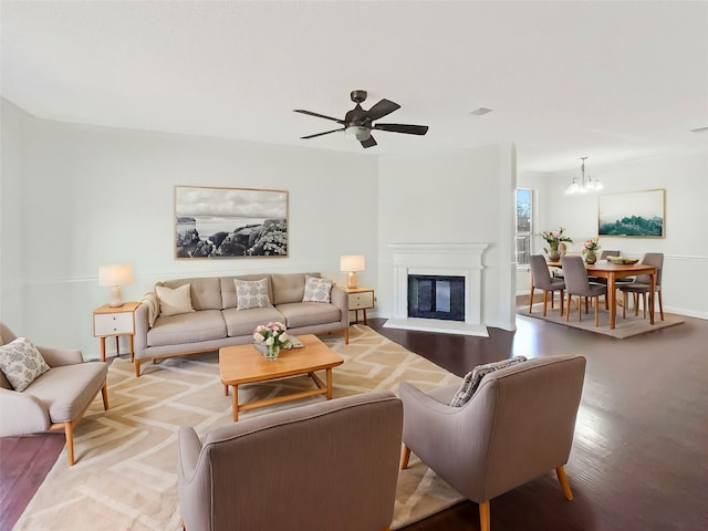 living room featuring ceiling fan with notable chandelier