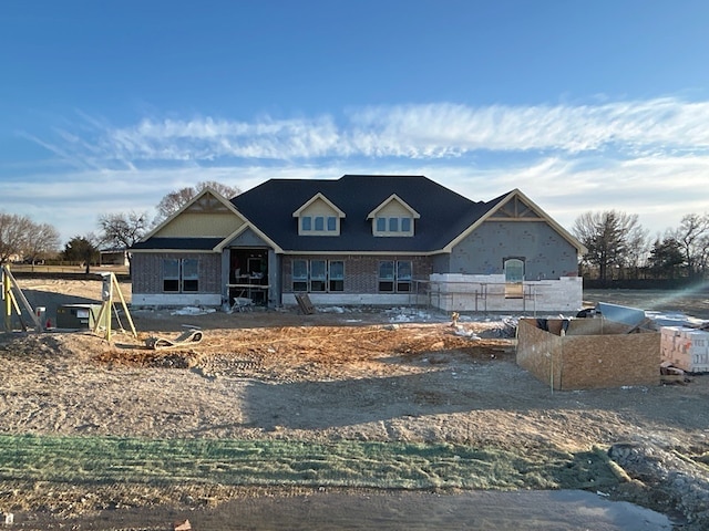 property under construction featuring brick siding