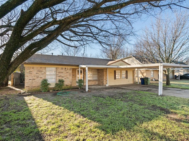 ranch-style house with a front yard and a carport