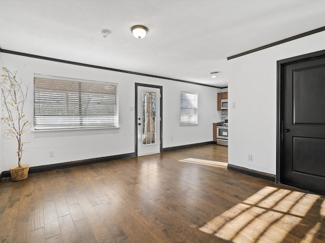 entrance foyer featuring dark wood-type flooring and crown molding