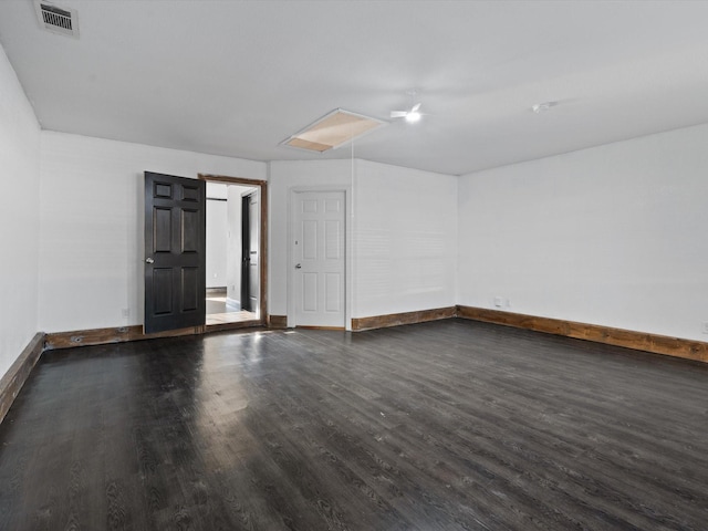 spare room featuring dark wood-type flooring