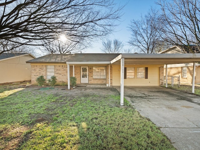 single story home with a front yard and a carport