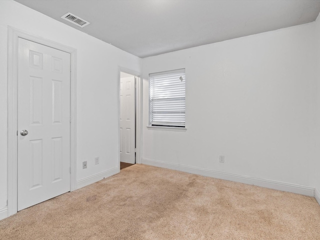 unfurnished bedroom with light colored carpet