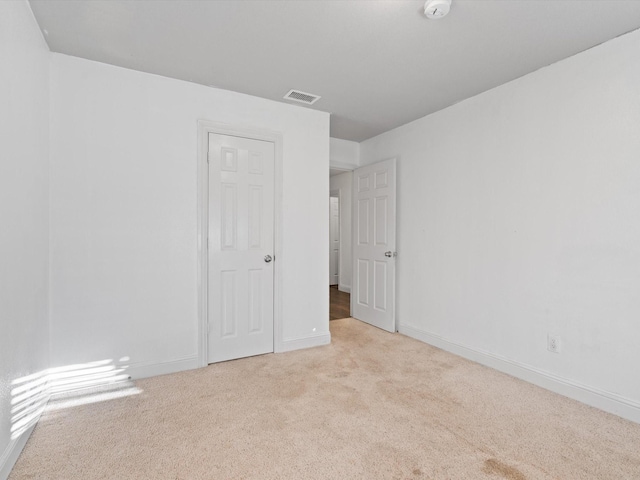 empty room with light colored carpet