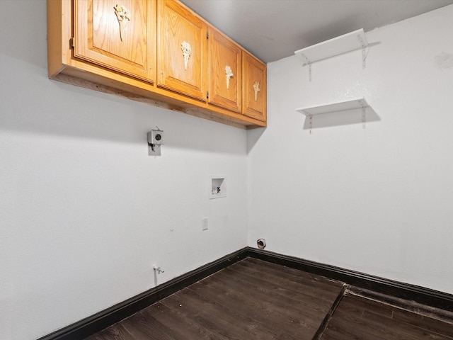 washroom featuring hookup for a washing machine, dark hardwood / wood-style floors, and cabinets