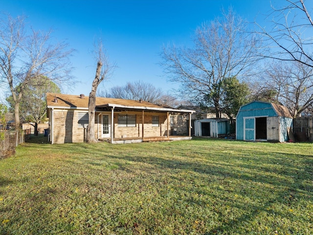 back of property with a yard and a storage unit