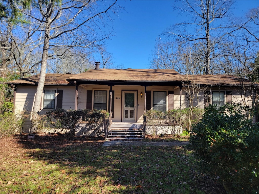 ranch-style house with a front lawn and a porch