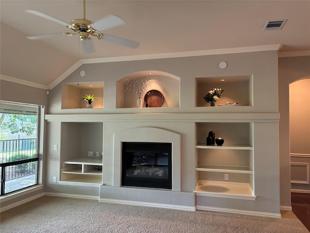 10104 Southpoint Ct, Denton, TX 76207 - detailed view of built in features, carpet, ornamental molding, a glass covered fireplace, and a ceiling fan